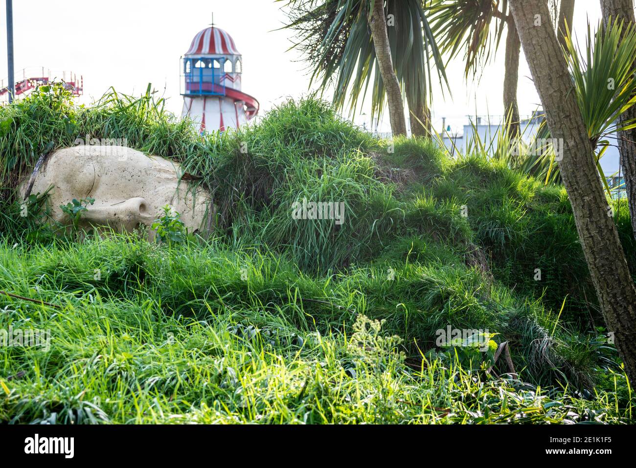 Sleeping giant figure in The Shrubbery, Cliff Gardens in Southend on Sea, Essex, UK. Stone face in landscaped green space Stock Photo