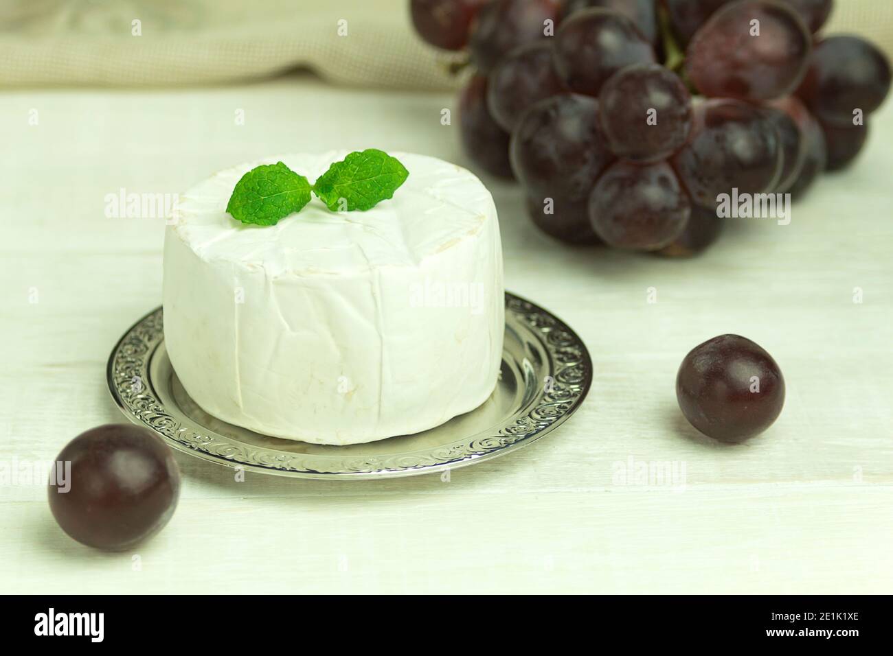 Camembert cheese and grapes closeup with space for text. Camembert