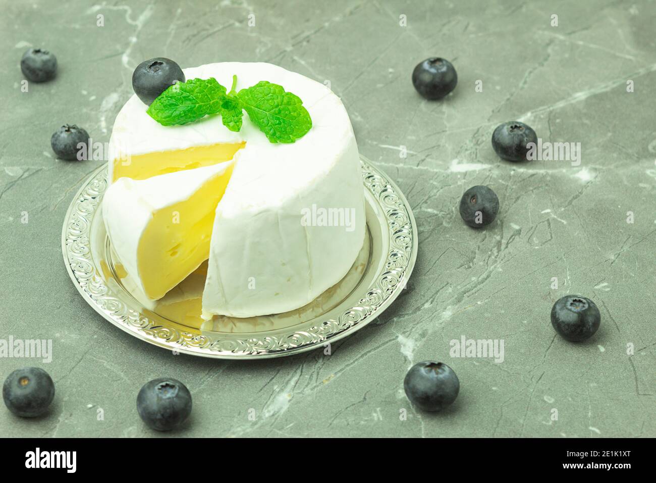 Camembert cheese closeup with space for text. Camembert sliced in