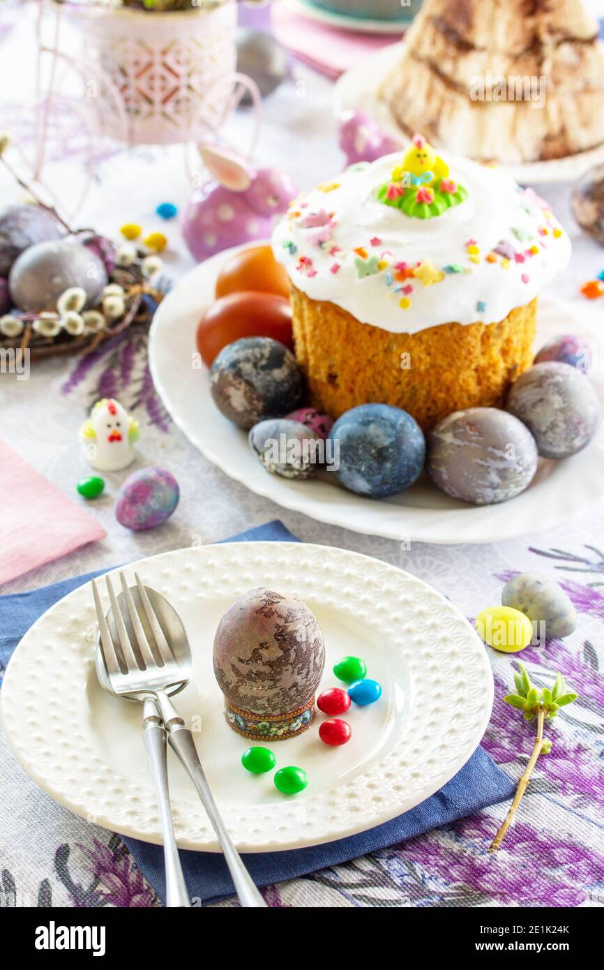 Festive table setting. Easter table with Easter orthodox cakes and Easter eggs. Stock Photo