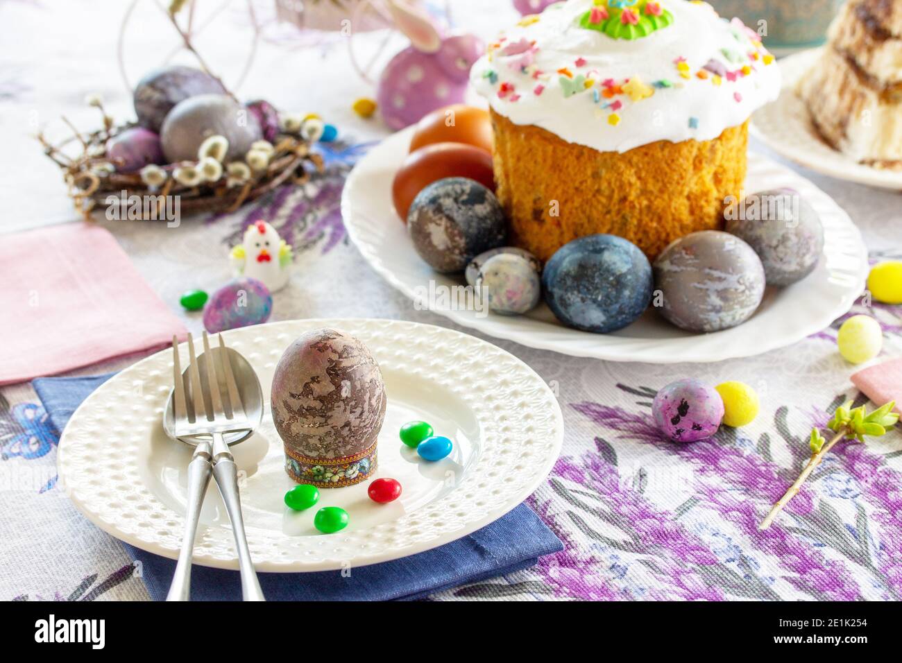 Festive table setting. Easter table with Easter orthodox cakes and Easter eggs. Stock Photo