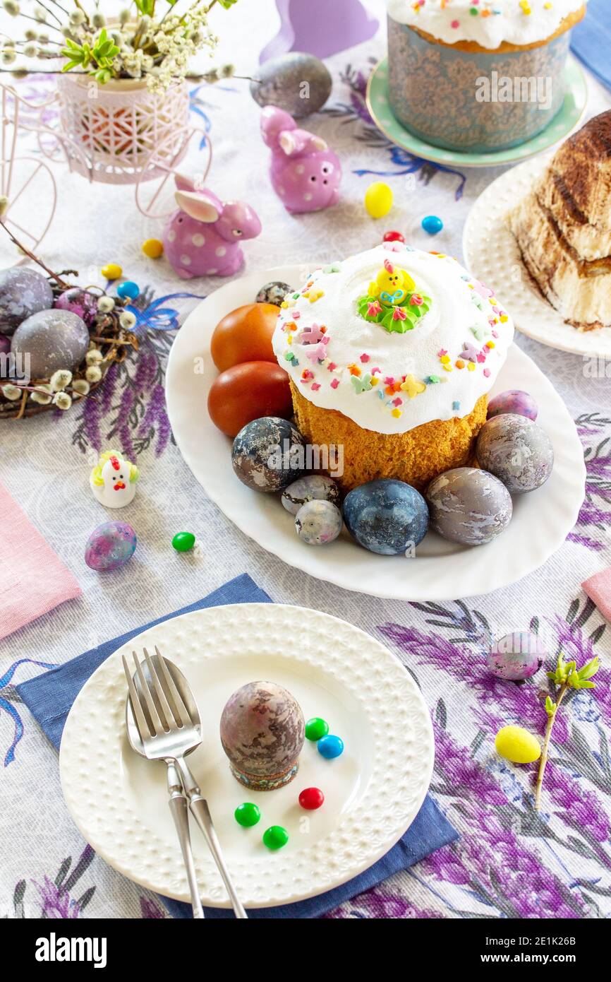 Festive table setting. Easter table with Easter orthodox cakes and Easter eggs. Stock Photo