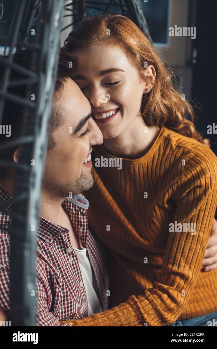 Ginger freckled lady and her lover are having a date on valentines day embracing and smile together Stock Photo