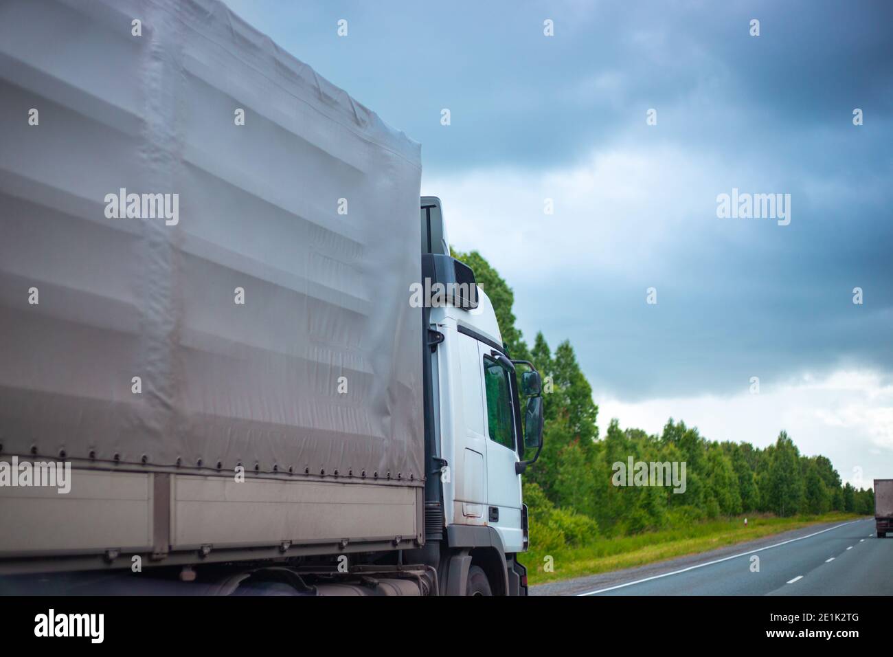 Transport Rodes Cars freight transport rides on the highway in the summer. Cargo ...