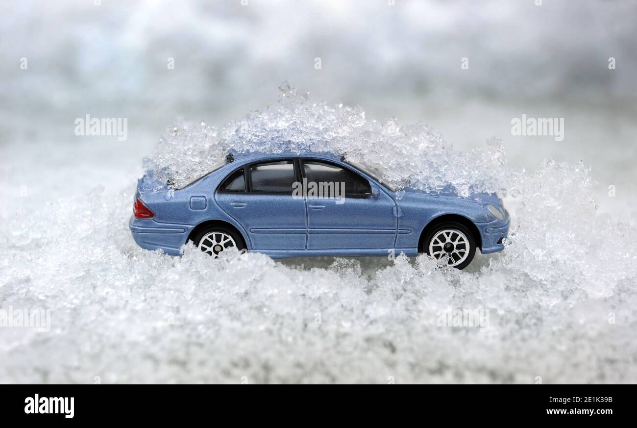 MODEL CAR IN ICY CONDITIONS RE WINTER MOTORING WEATHER ICE ETC UK Stock Photo