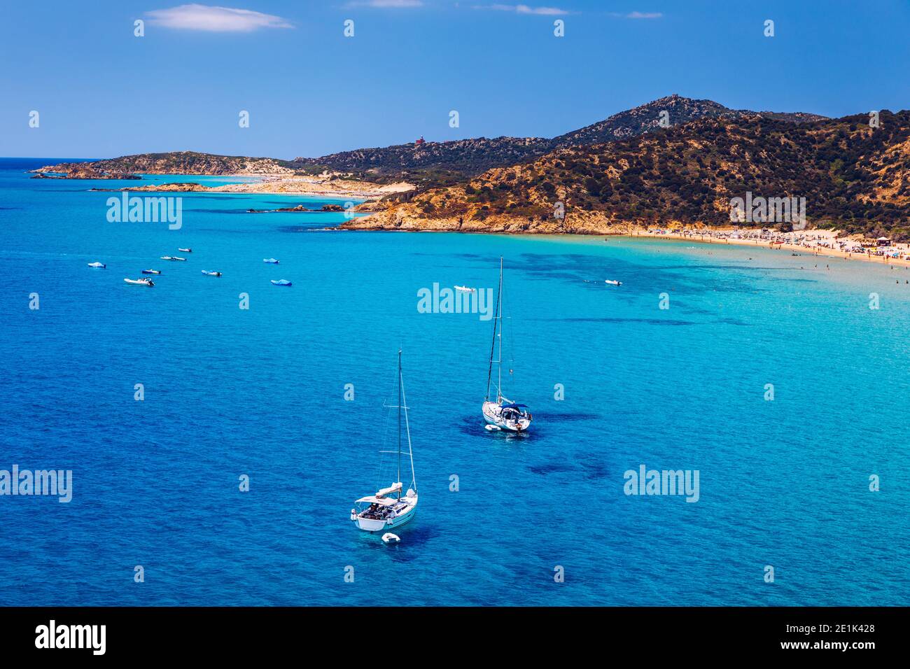 Aerial view of anchored sailing yacht in emerald sea. Aerial view of a