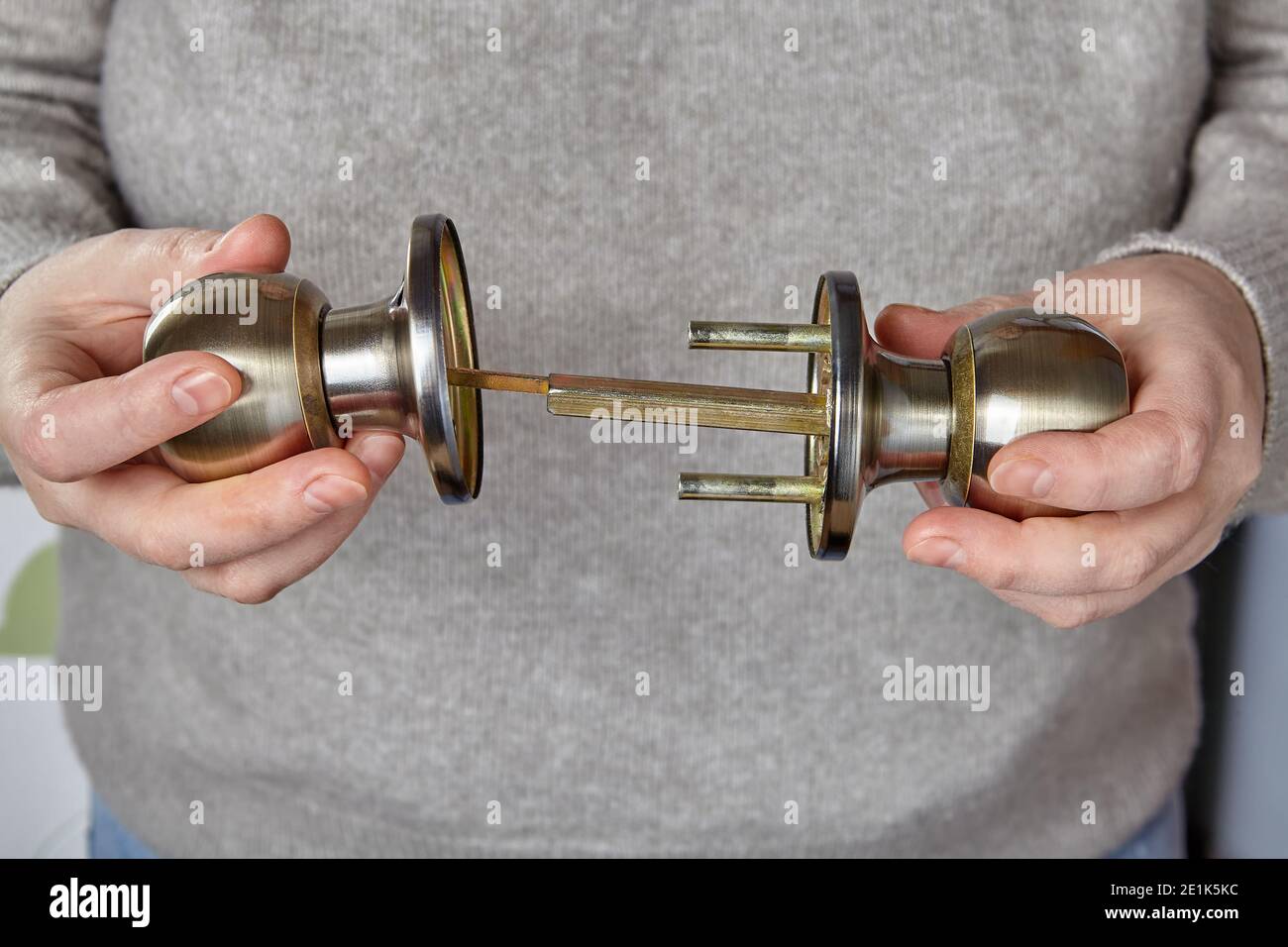 Locksmith inserts spindle into handle of interior door to check operation of lock mechanism