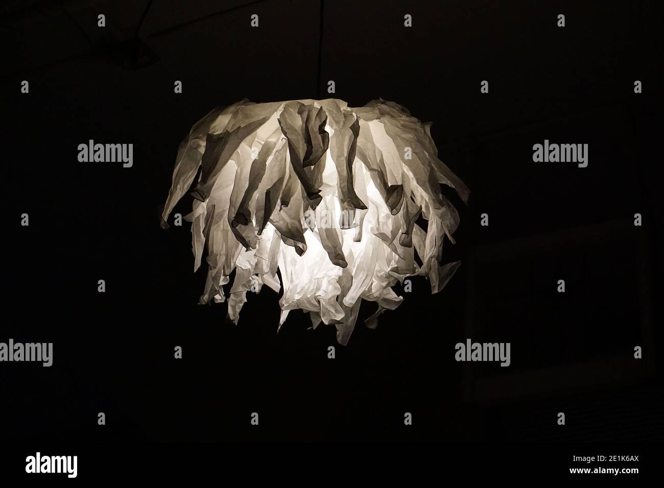 Krusning pendant paper lamp from IKEA, creatively into strips and crumpled for a unique effect. Low budget home decorating idea Stock Photo - Alamy