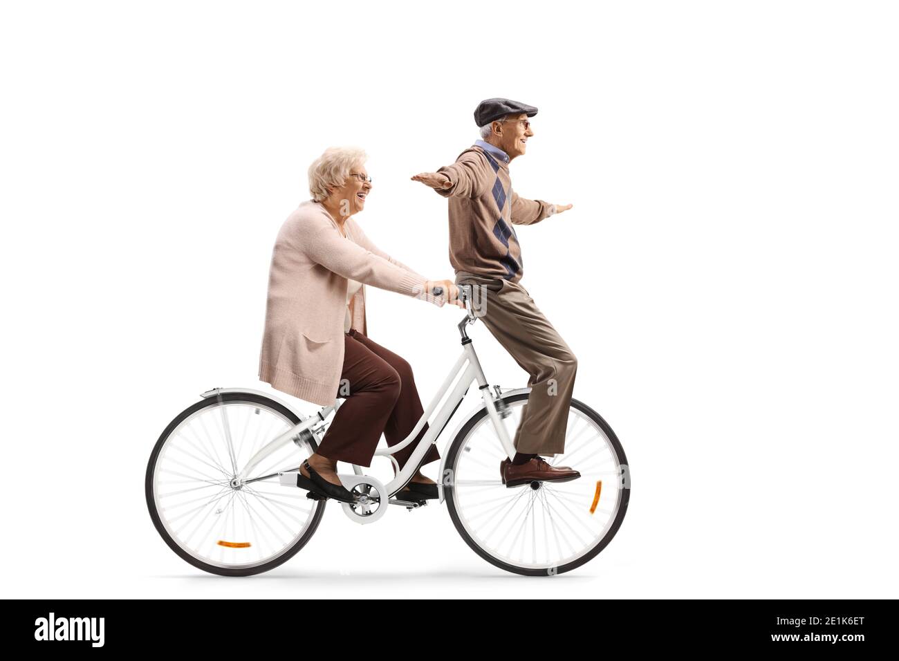 Elderly couple riding on a bicycle isolated on white background Stock Photo