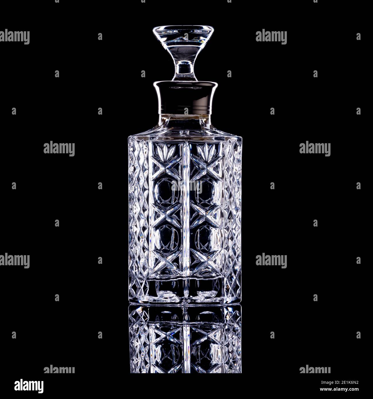 Straight sided glass decanter on black background Stock Photo