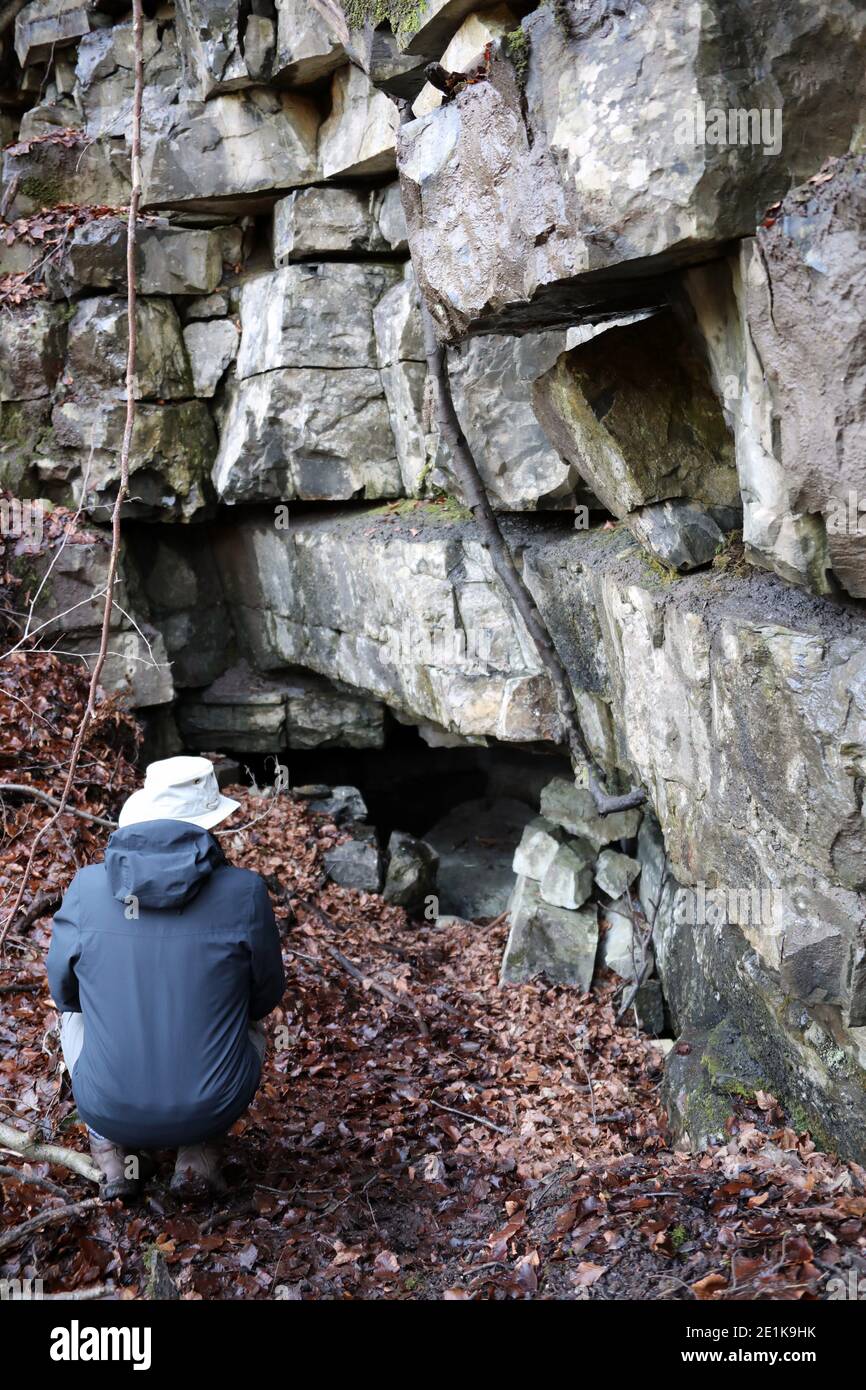 Geologist in Nettler Dale at the site of the historic Ashford Black Marble Mine Stock Photo