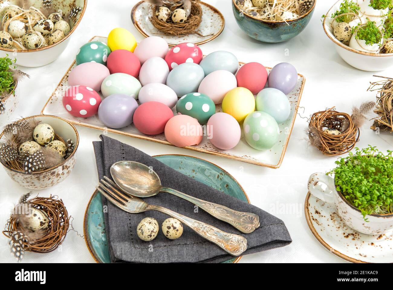 Festive table place setting. Easter decoration colored eggs Stock Photo