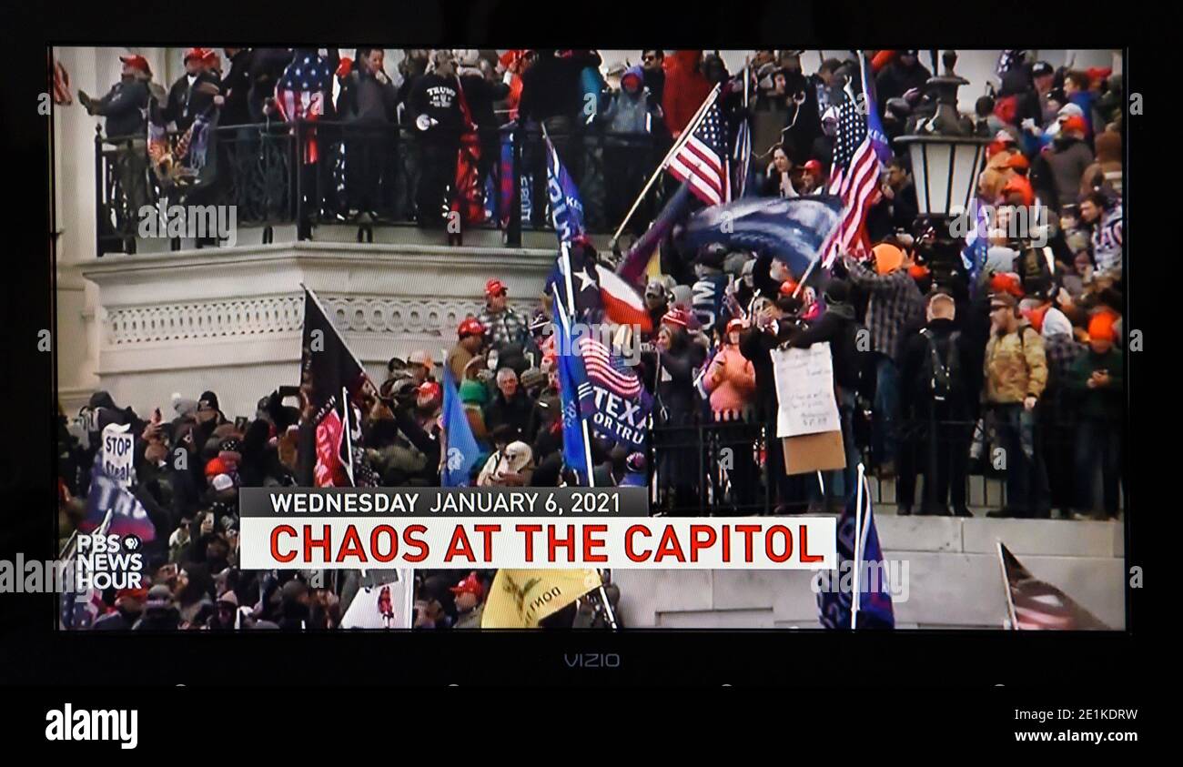 A PBS television screenshot of the U.S. Capitol Building being stormed by pro-Donald Trump demonstrators on Jan. 6, 2020. Stock Photo