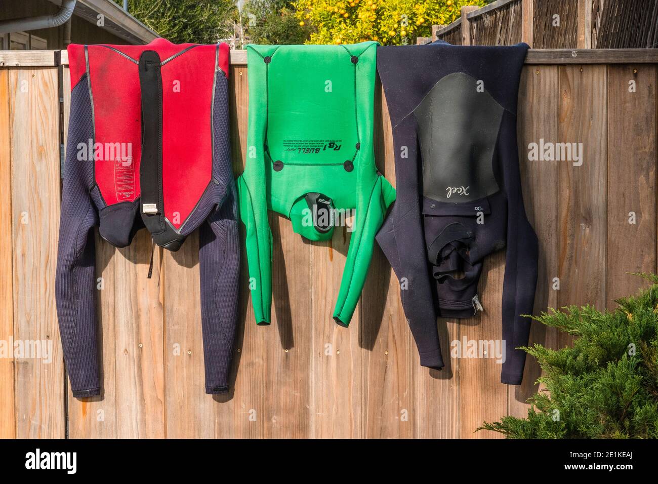 Wetsuits hanging to dry Stock Photo Alamy