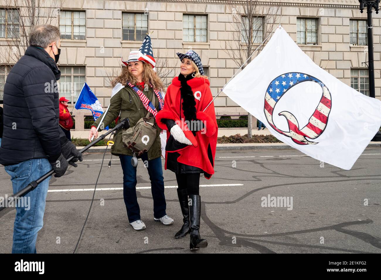 Two women wearing Qanon outfits and flag speak to a reporter during a Trump Rally in Washington, DC Stock Photo