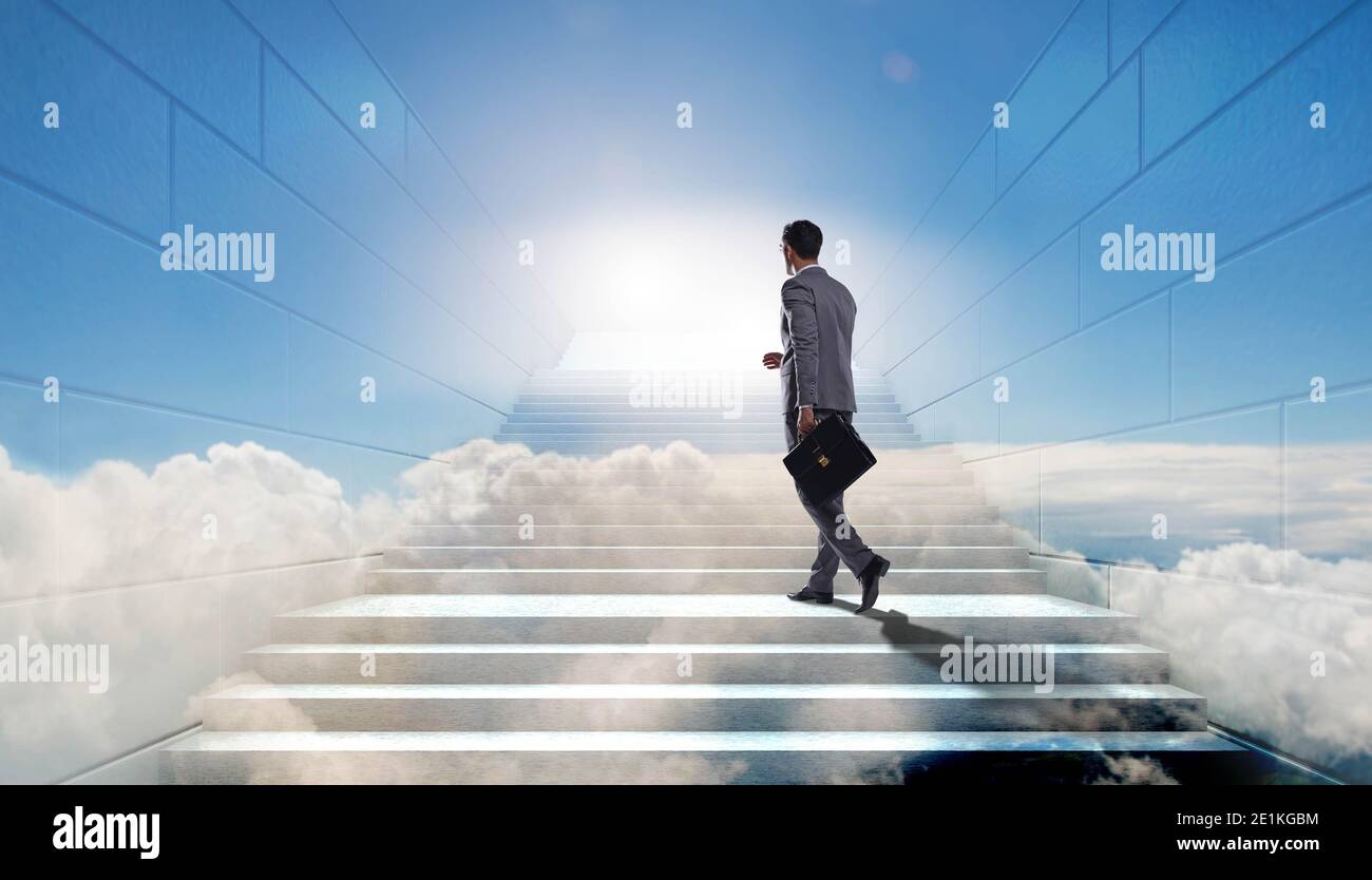 Businessman climbing up challenging career ladder in business concept ...