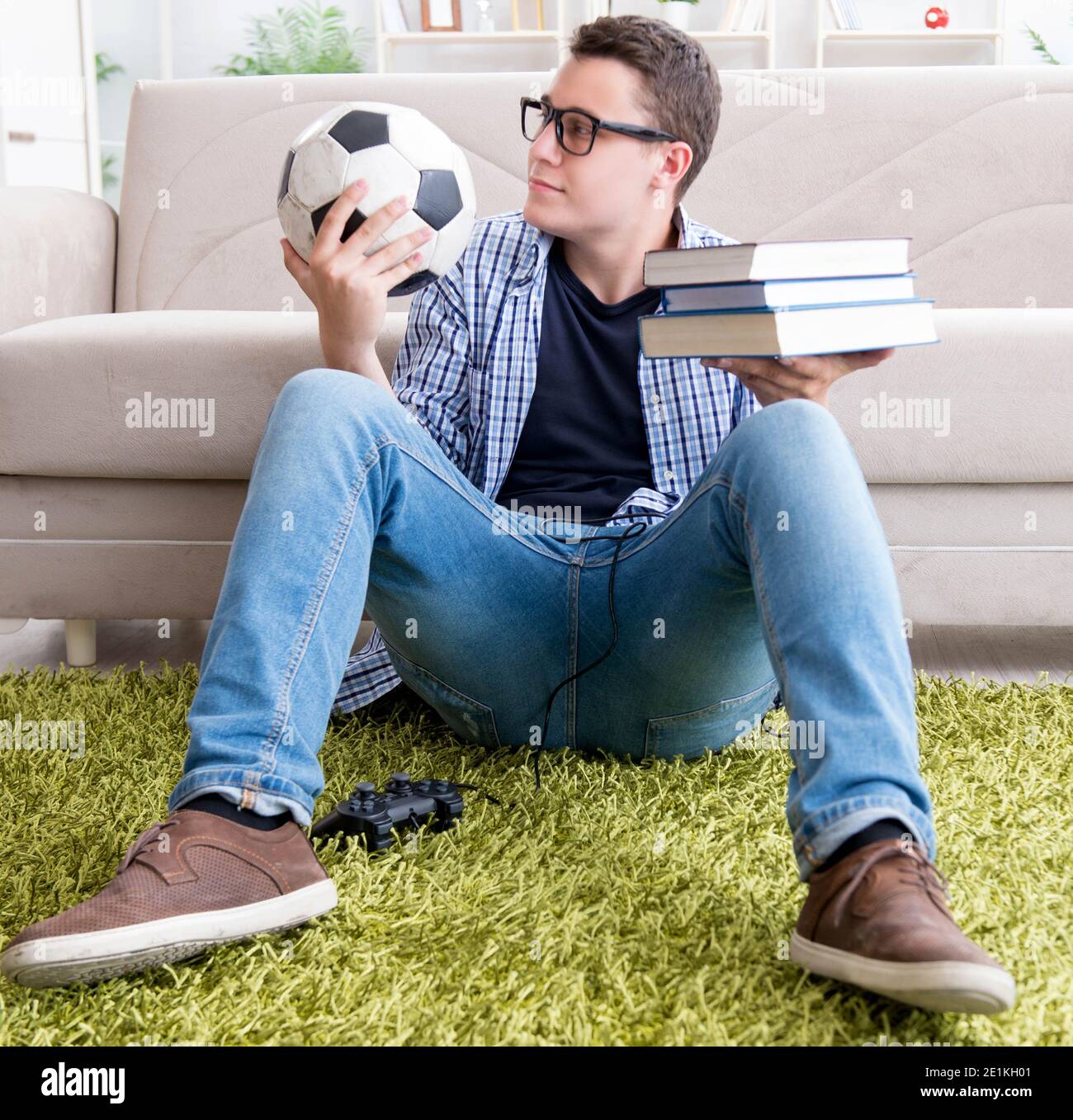 Boy trying to balance books hi-res stock photography and images - Alamy