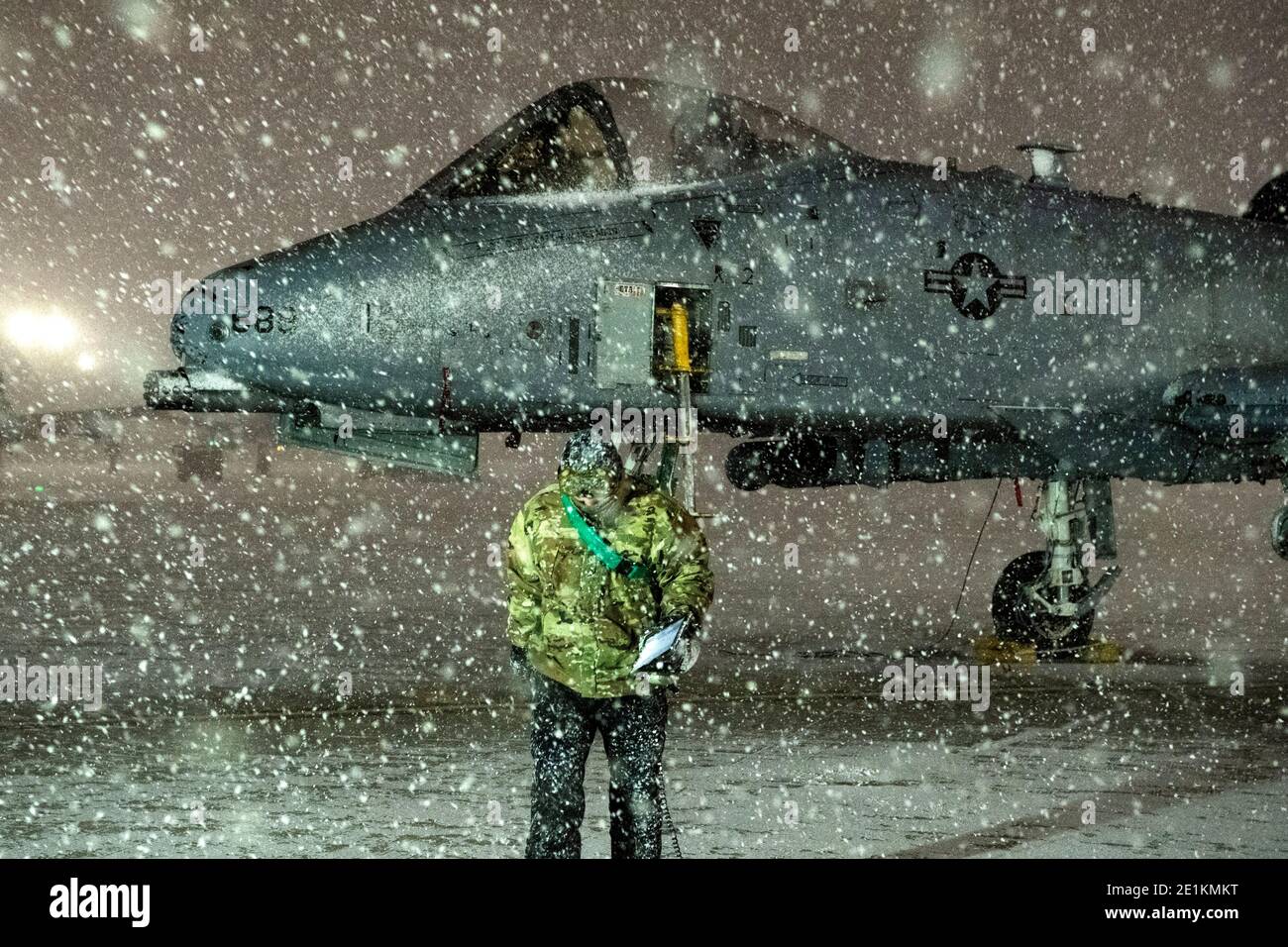 Pyeongtaek, South Korea. 06th Jan, 2021. A U.S. Airman prepares an an A-10 Thunderbolt II close air support fighter aircraft for flight operations during a heavy snowfall at Osan Air Base January 6, 2021 in Pyeongtaek, South Korea. Credit: Planetpix/Alamy Live News Stock Photo