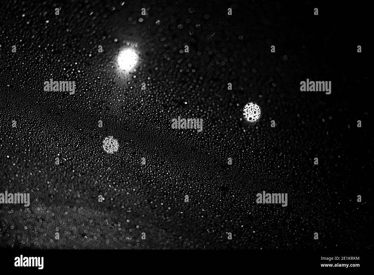 Glass with rain drops against dark background Stock Photo - Alamy