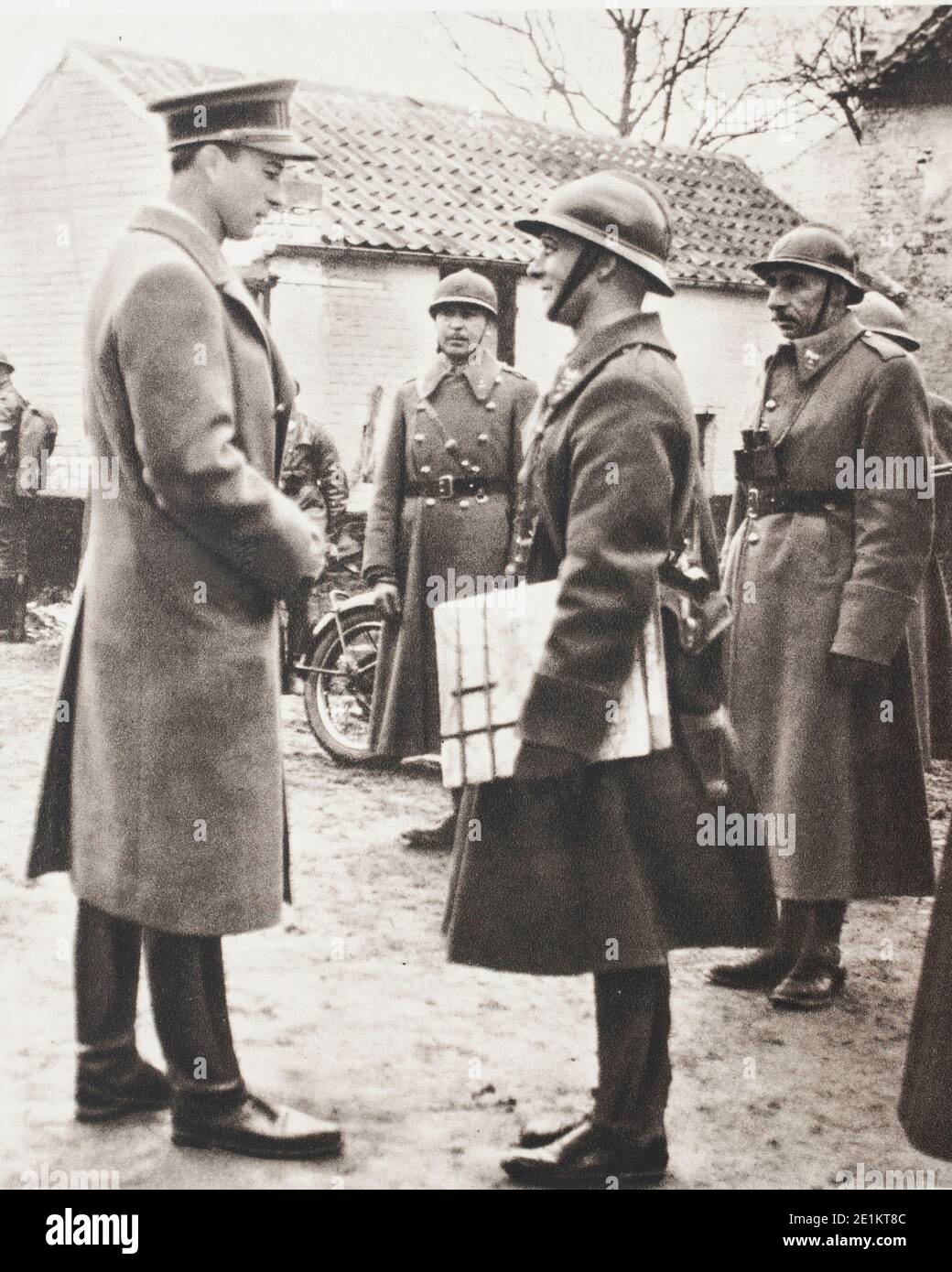 King Leopold III (1901 – 1983)  inspects the positions of the first line. As commander-in-chief of the Belgian Army, the King often appeared unexpecte Stock Photo