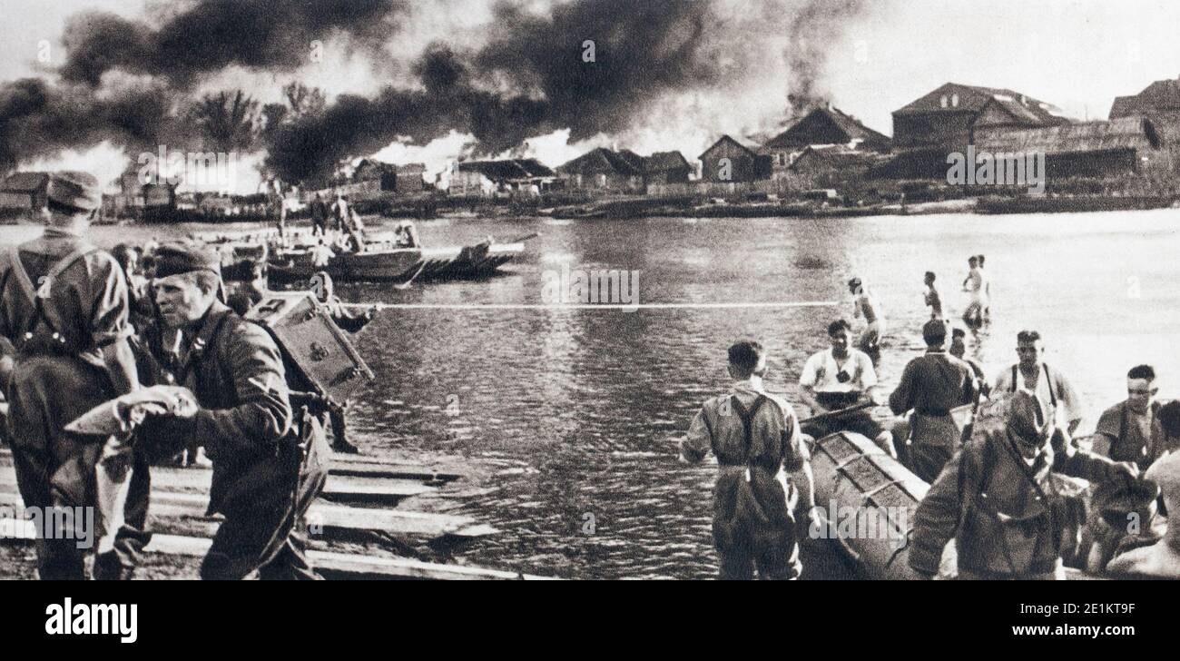 German troops on the East Front (1941). Everything was an obstacle to the Germans: the plain, the rivers, the destroyed bridges, the burning villages. Stock Photo