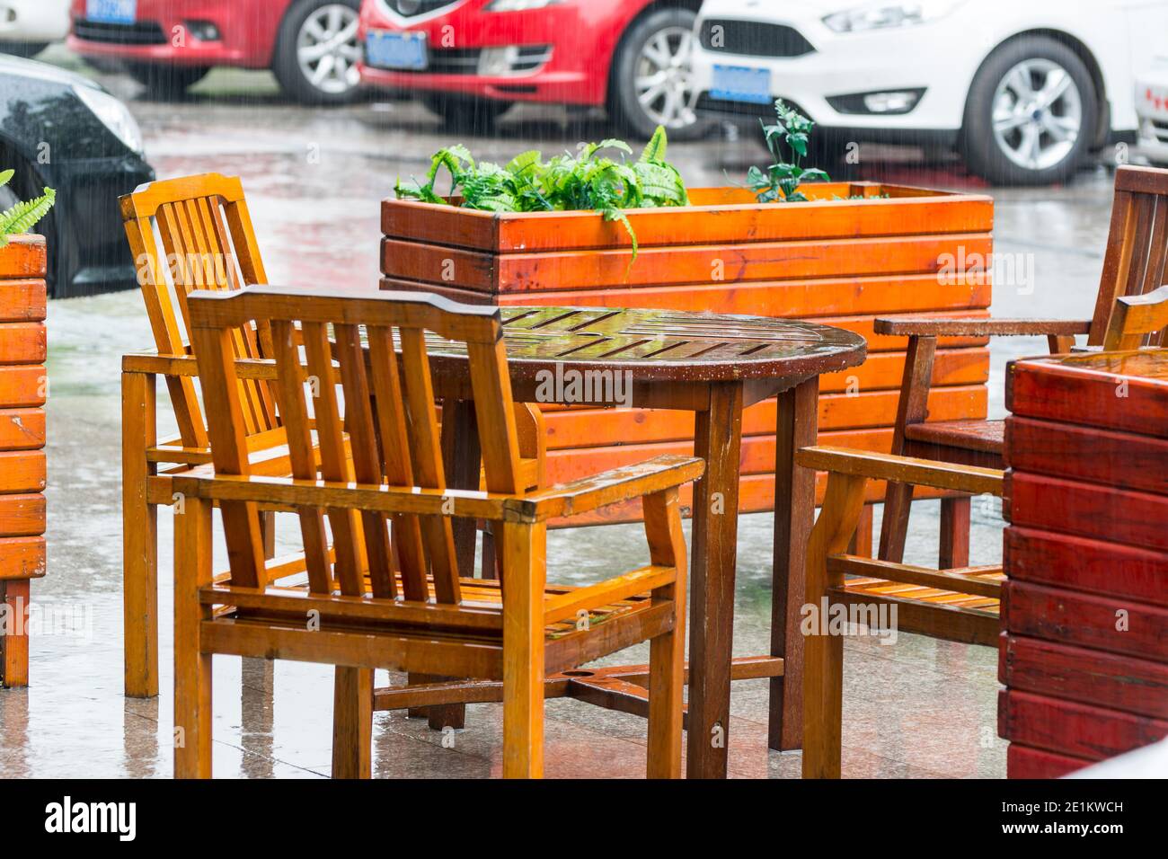Chinese restaurant table and chair under raining Stock Photo - Alamy