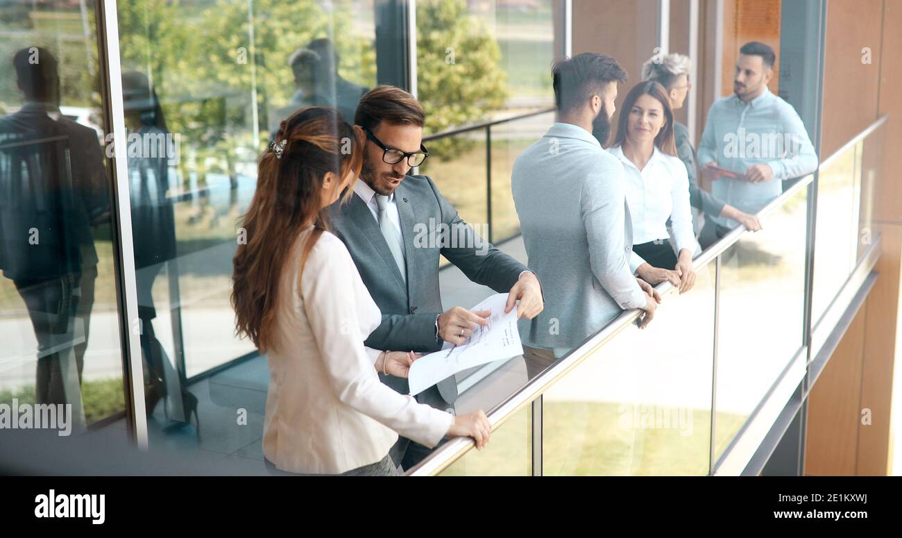 Business colleagues collaborating and discussing project plans Stock Photo