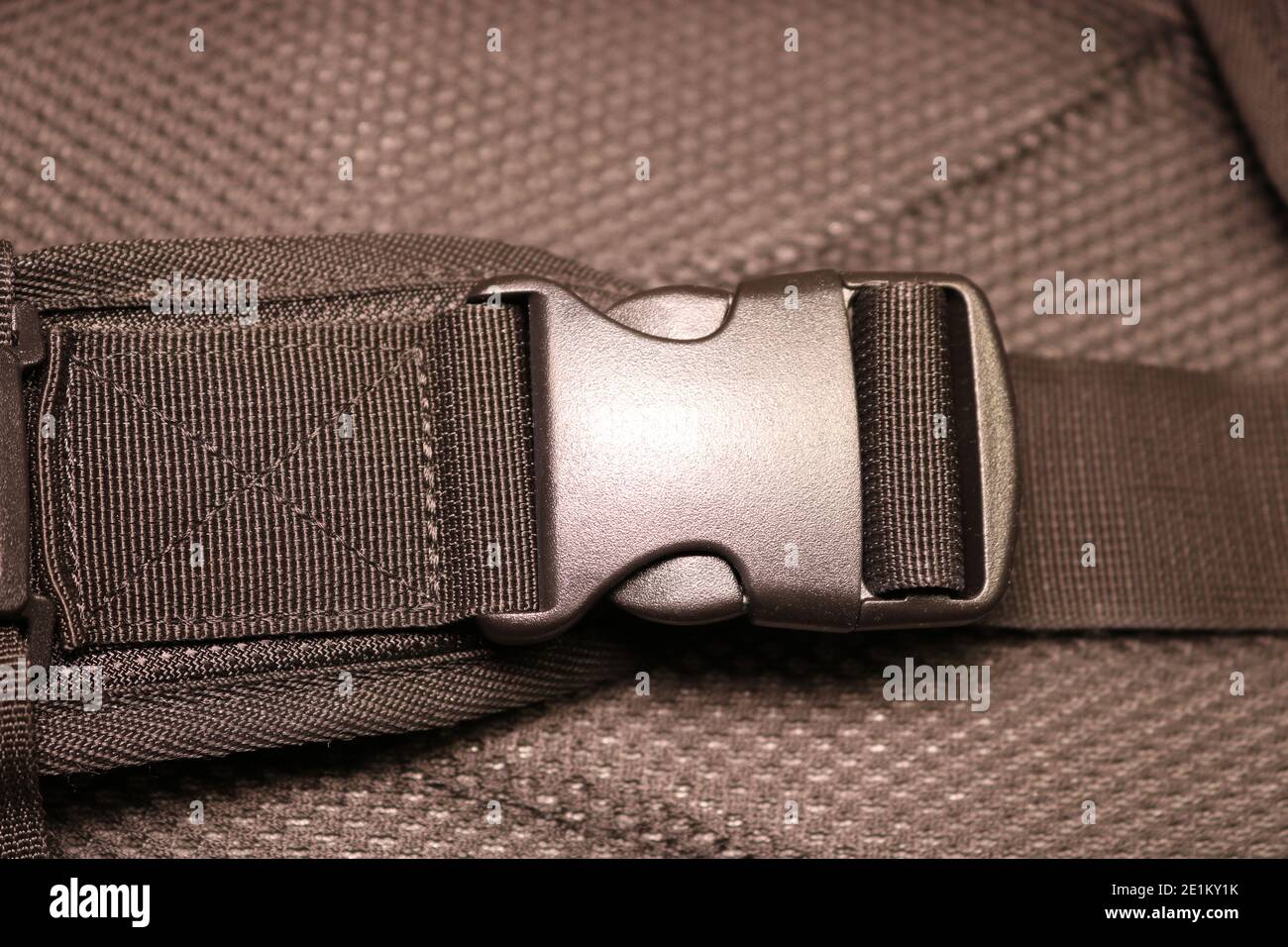 Black plastic buckle on the backpack. Plastic zip lock. Photo toned sepia.  Close-up Stock Photo - Alamy