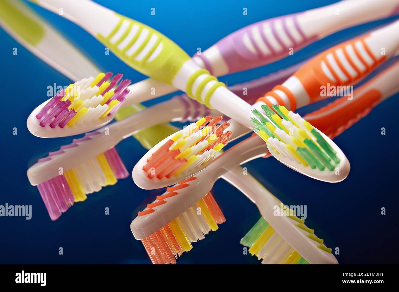 group of toothbrushes on a dark gradient background Stock Photo