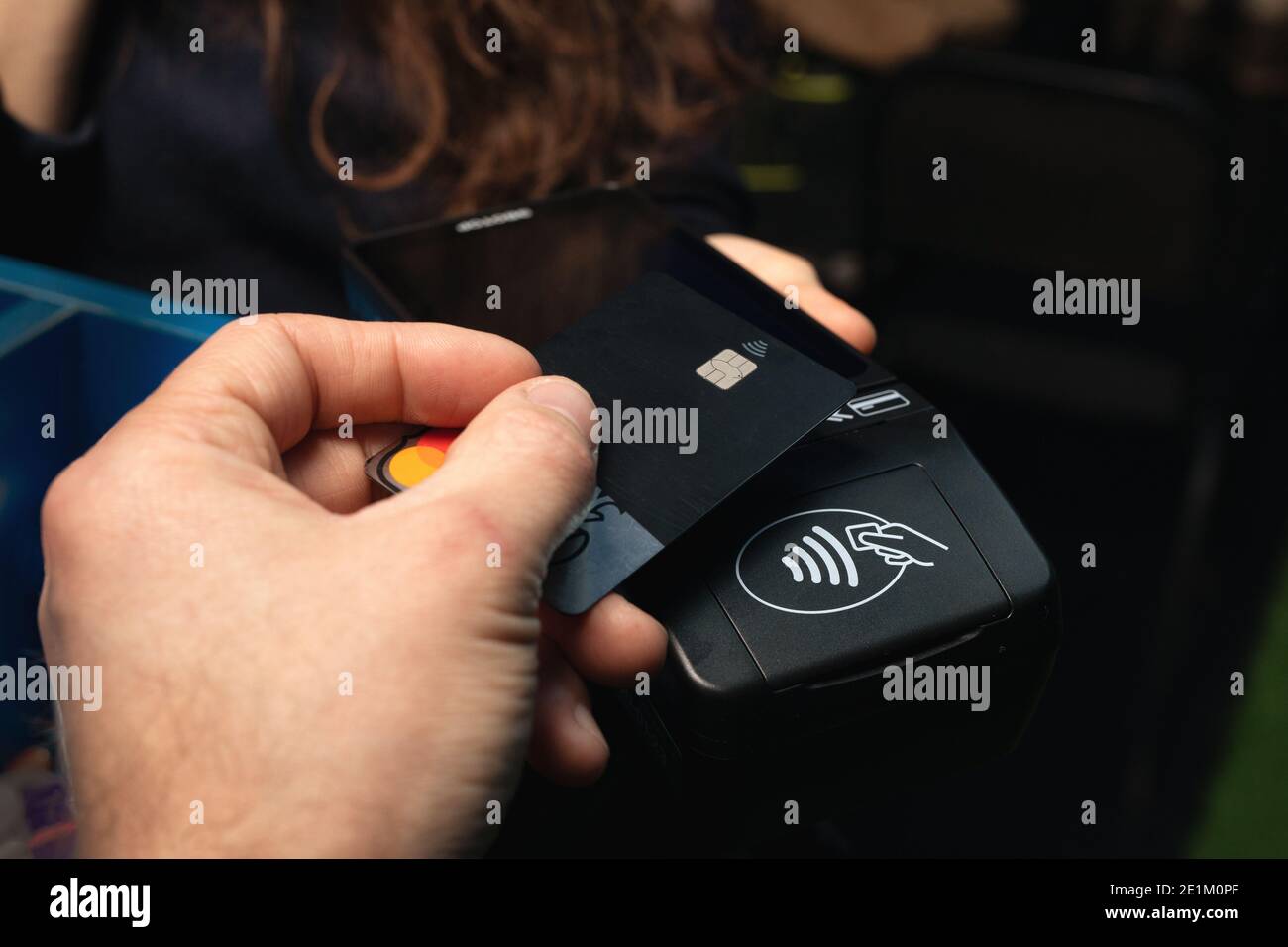 Close up of payment being made with contactless credit card with NFC ...
