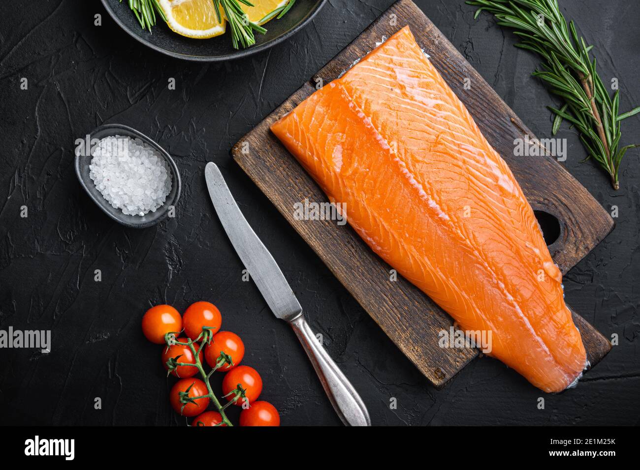 Fresh whole salmon fillet on black background, flat lay Stock Photo - Alamy