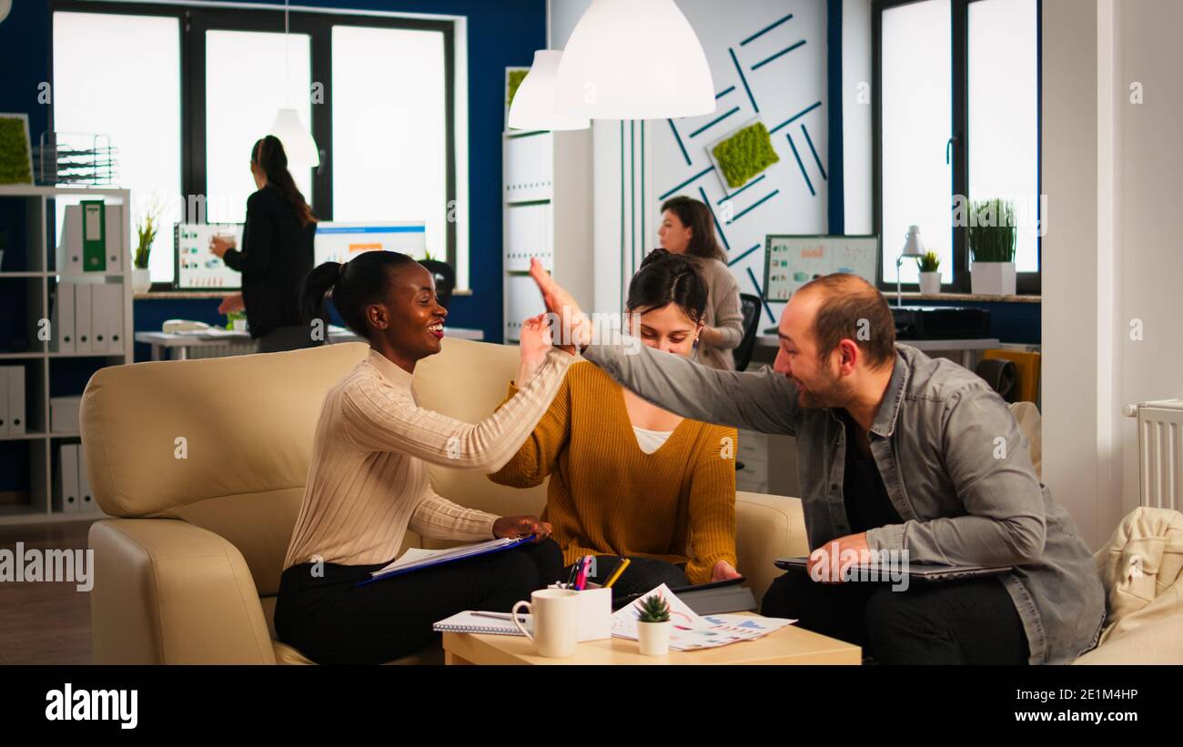 Happy leader motivate diverse employees business team give high five ...