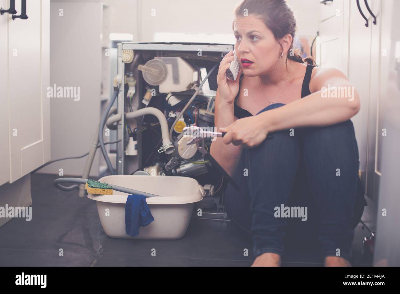 Woman needs a plumber to repair the leak Stock Photo