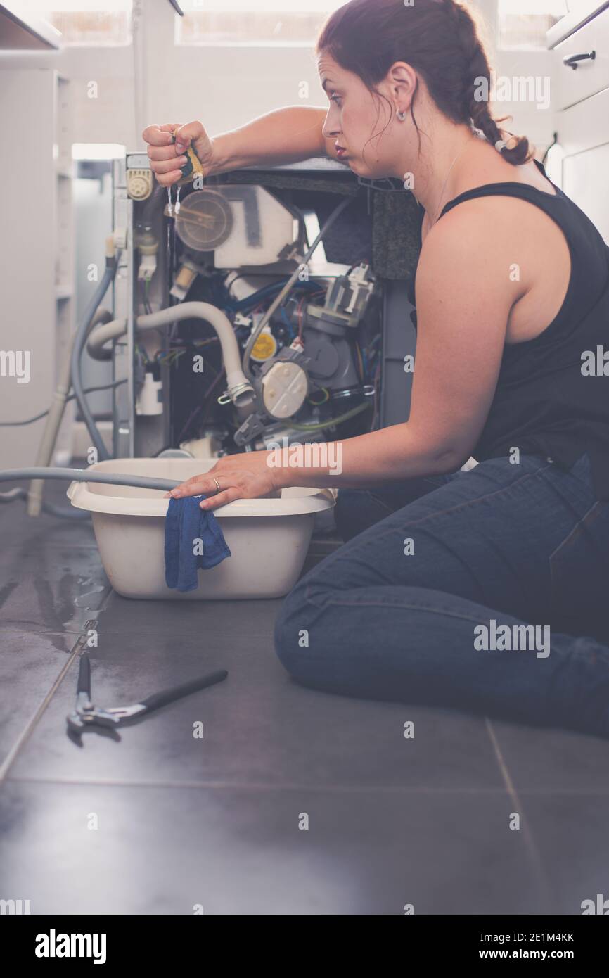 Woman needs a plumber to repair the leak Stock Photo