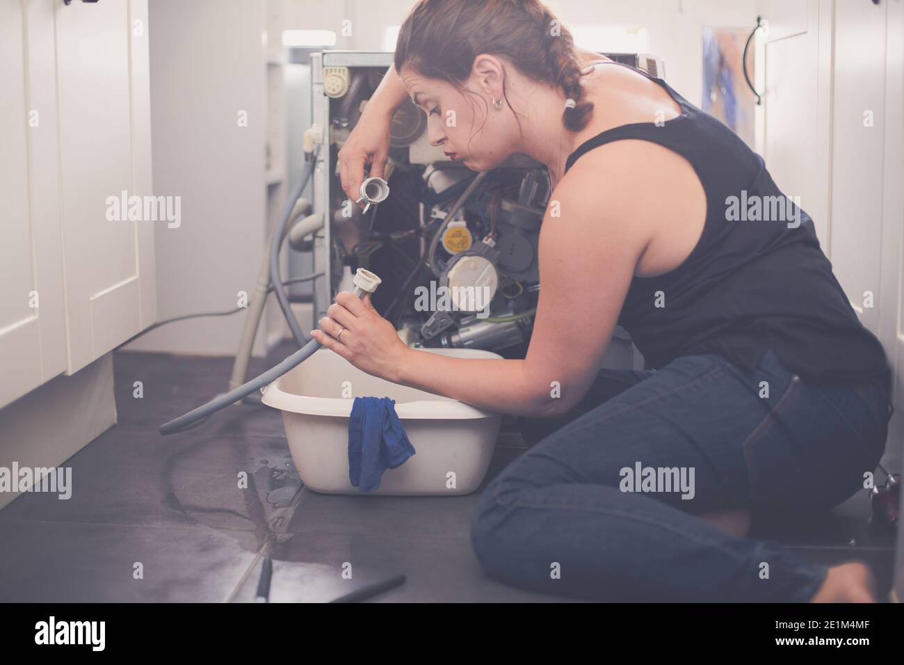 Woman needs a plumber to repair the leak Stock Photo