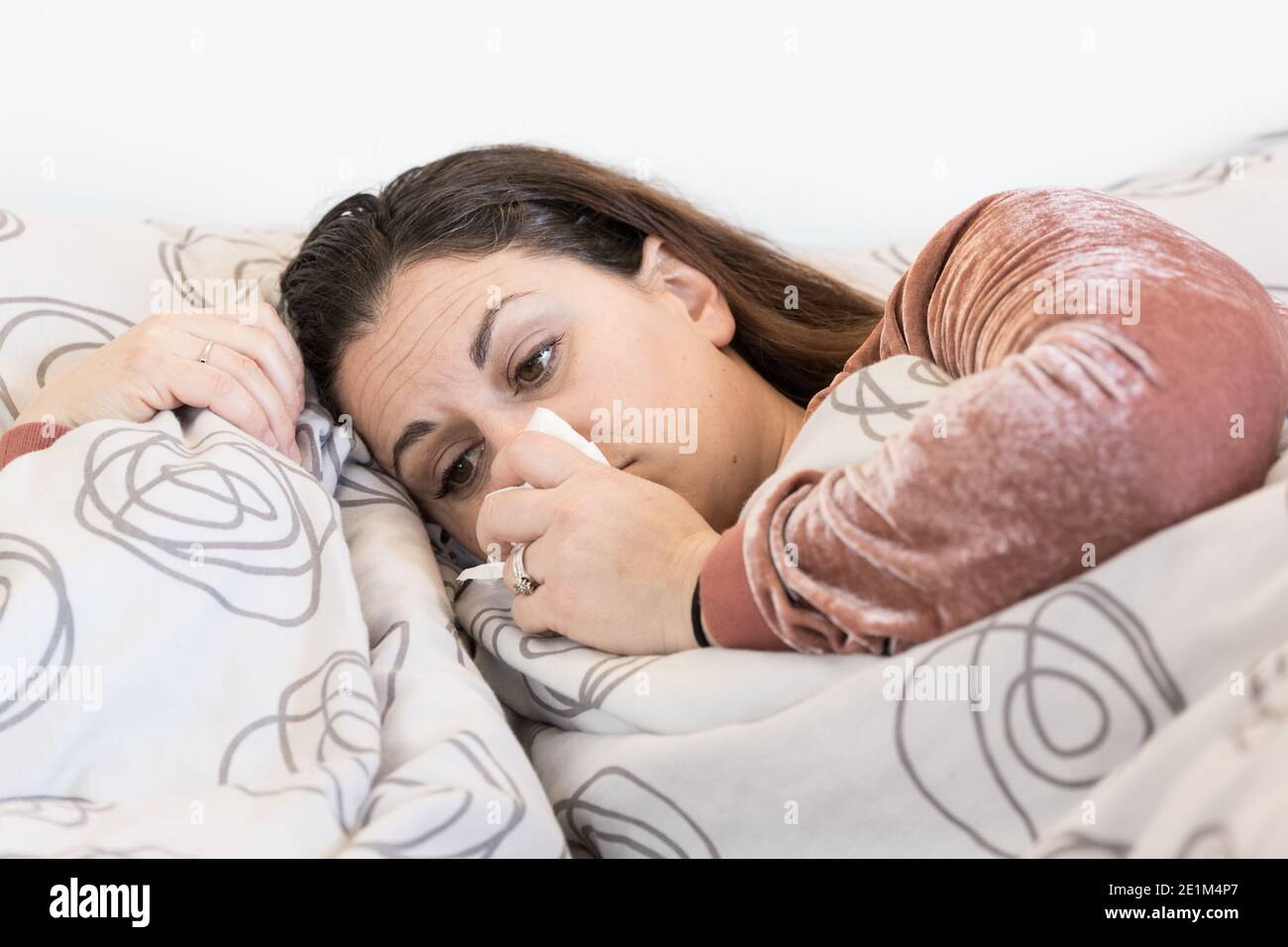 sick woman , flu or covid19 desease, cold and she has fever Stock Photo