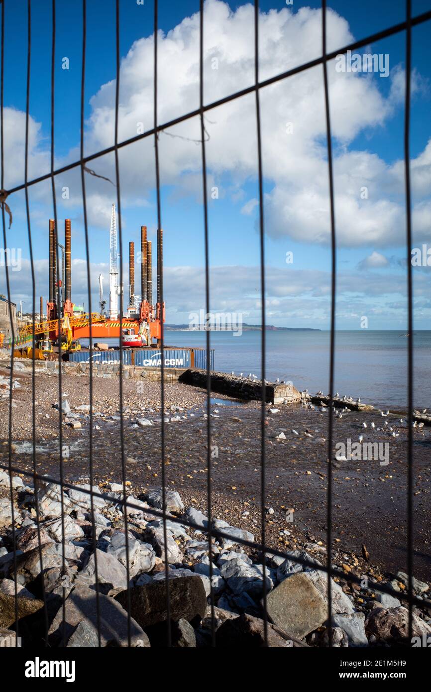 Wave Walker jack-up barge helping construction of a new bigger sea wall at Dawlish protecting the railway, Devon, England. Stock Photo