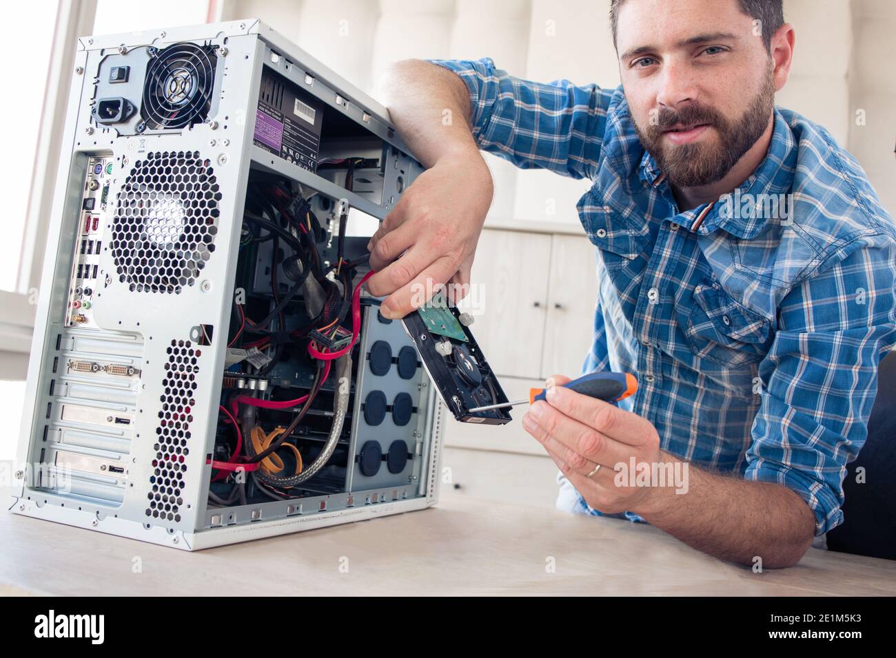 Engineer repairs computer's hard drive Stock Photo