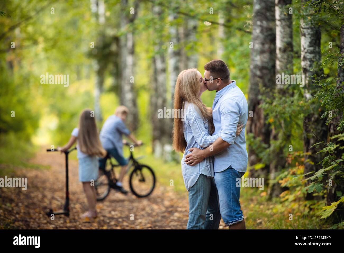 Rear view of family walking along autumn path in a park or forest Stock Photo