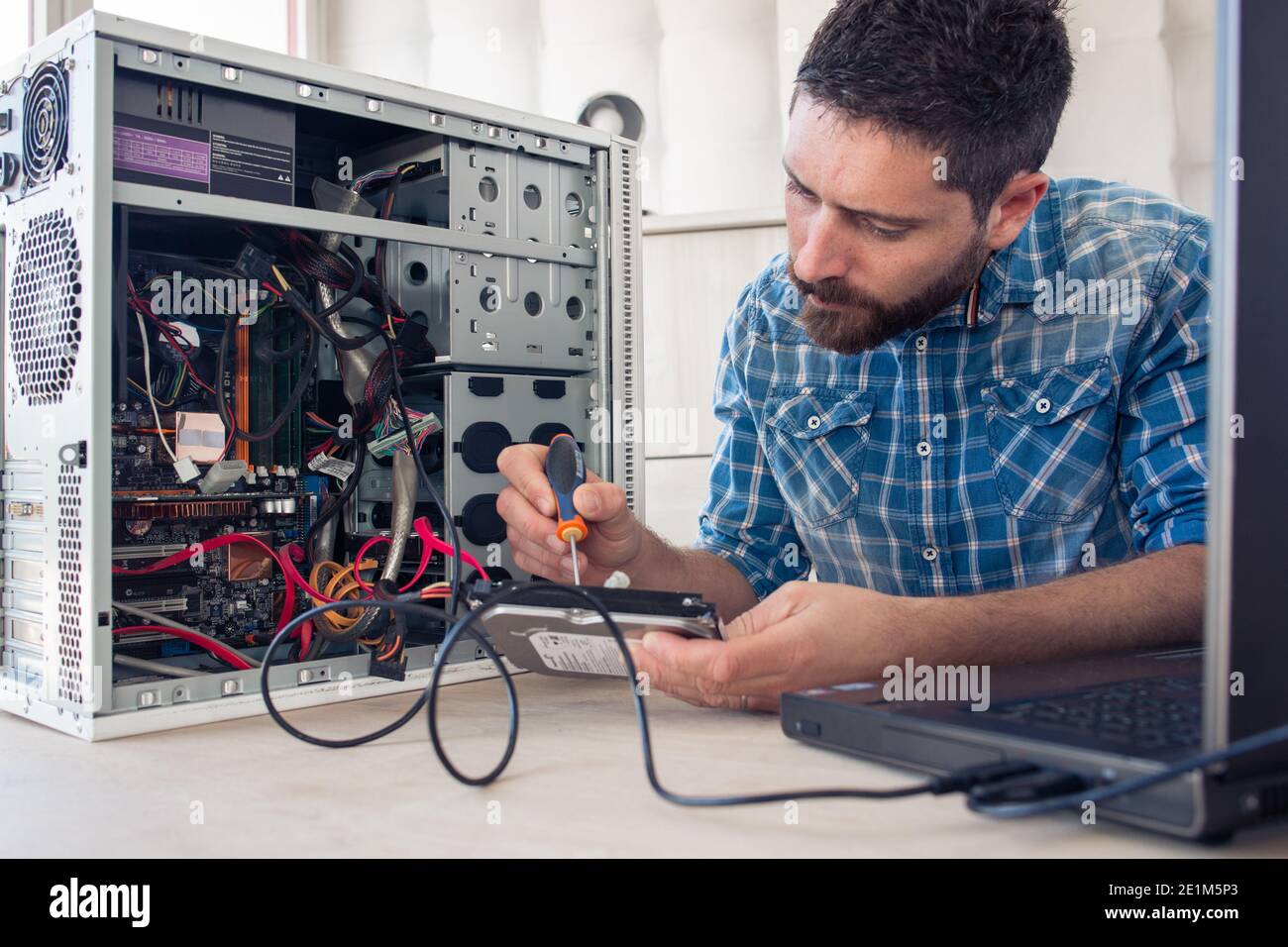 Engineer repairs computer's hard drive Stock Photo
