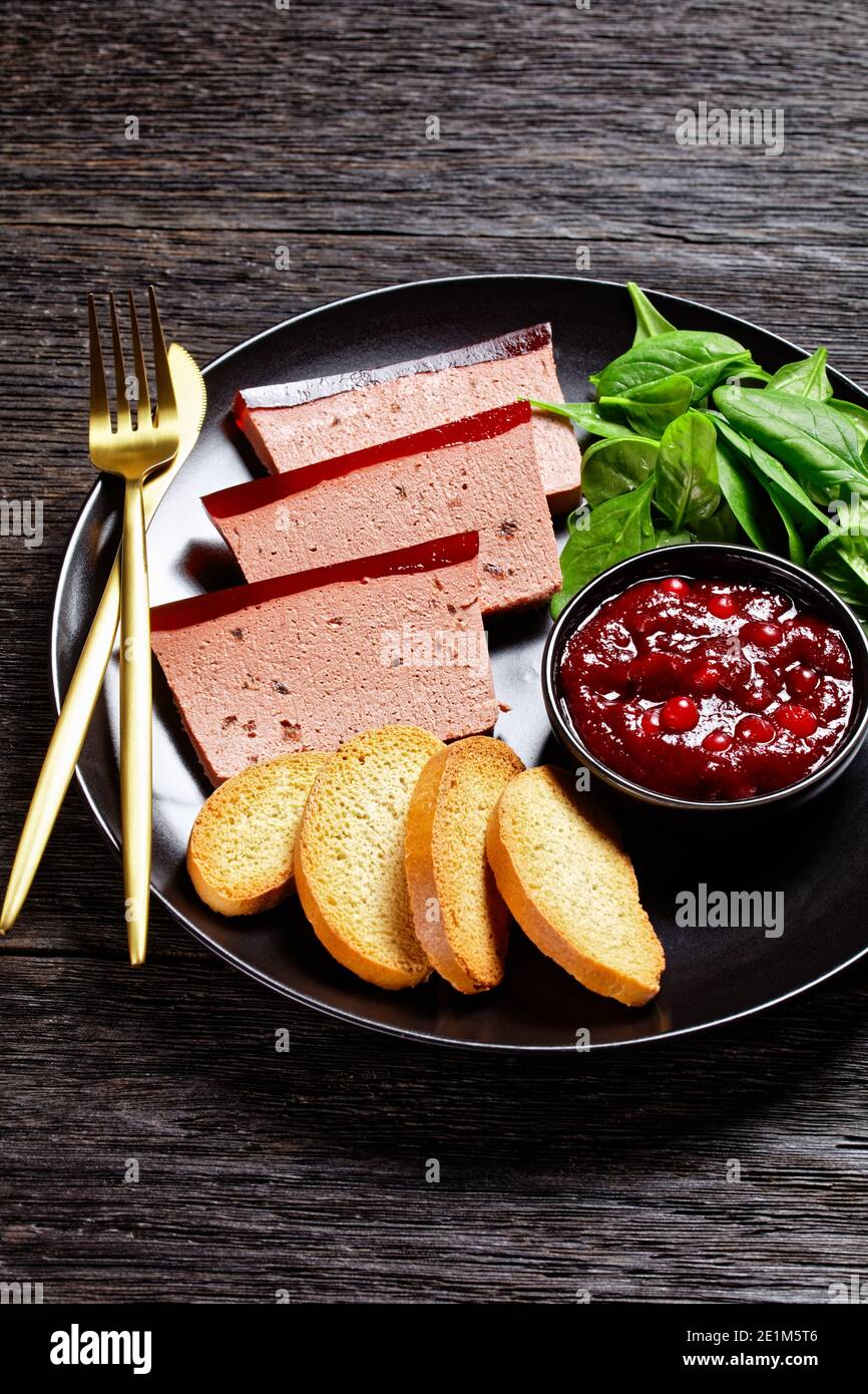 French dish duck liver pate with cranberry marmalade on top served on a