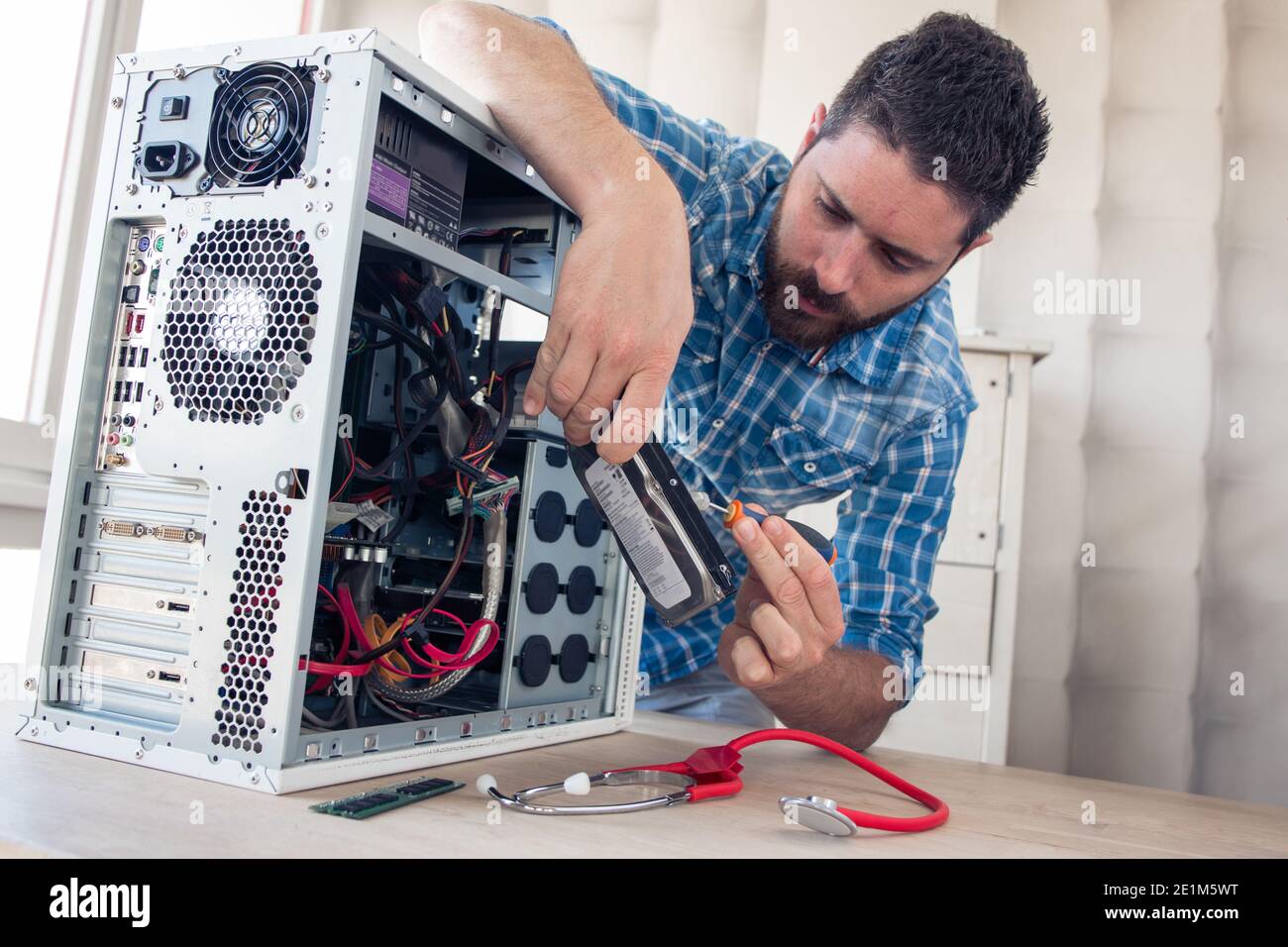 Engineer repairs computer's hard drive Stock Photo