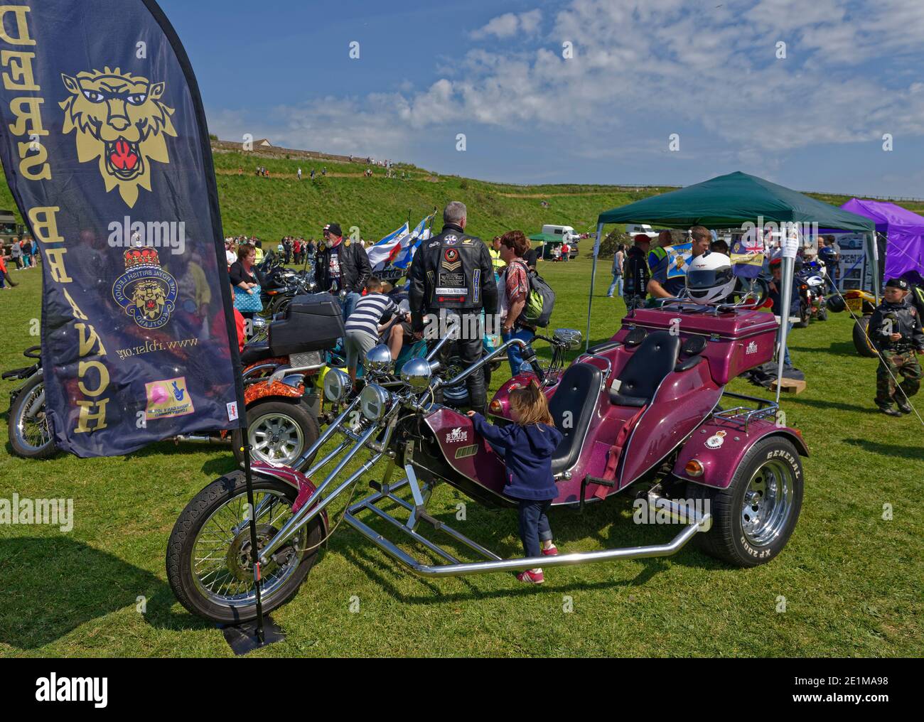 Two Motorbike Trikes parked up with Children playing around during the
