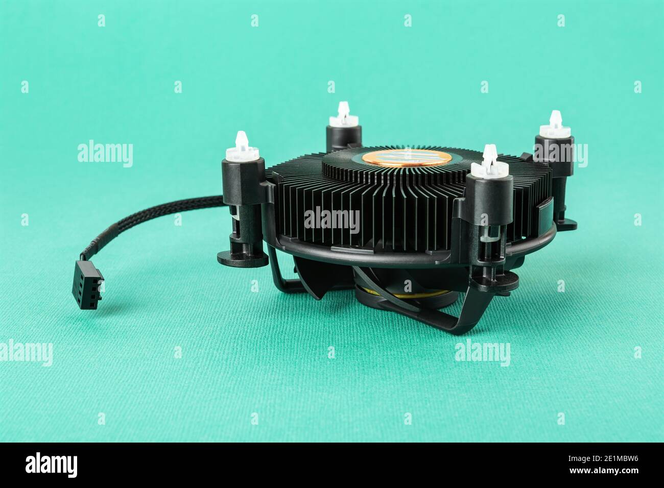 Computer CPU cooling fan radiator upside down on a turquoise blue green