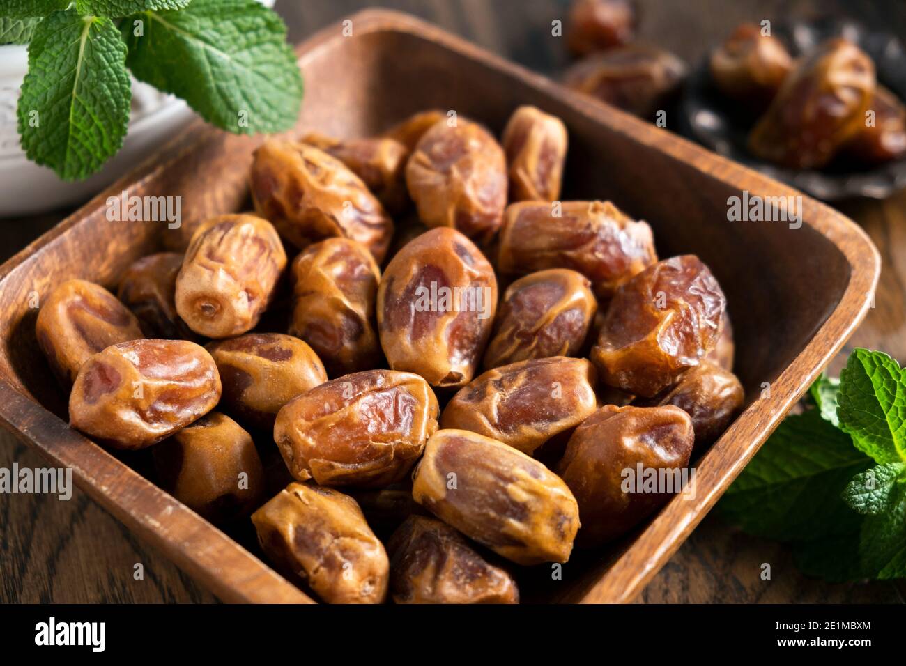 Dry palm dates in a wooden bowl. Yellow dates from Egypt, arabic food