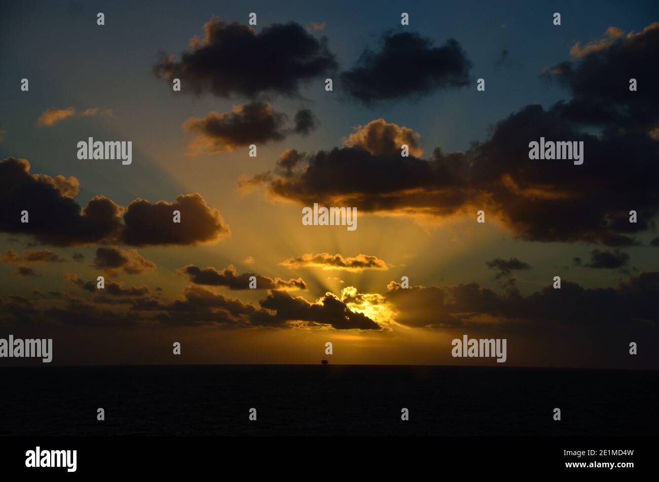 glowing sunset on sea with ship on horizon Stock Photo - Alamy