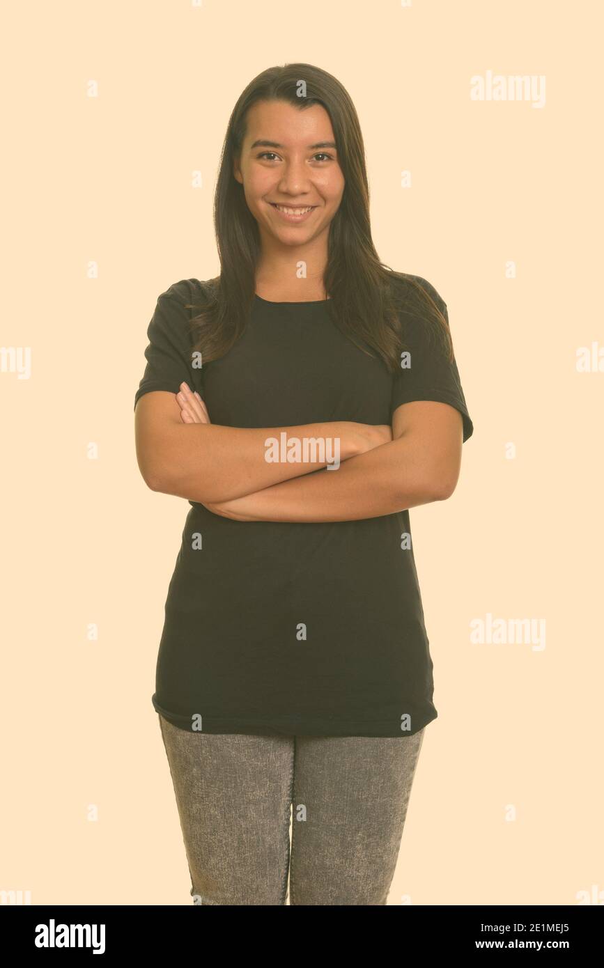 Young happy Caucasian woman smiling with arms crossed Stock Photo - Alamy