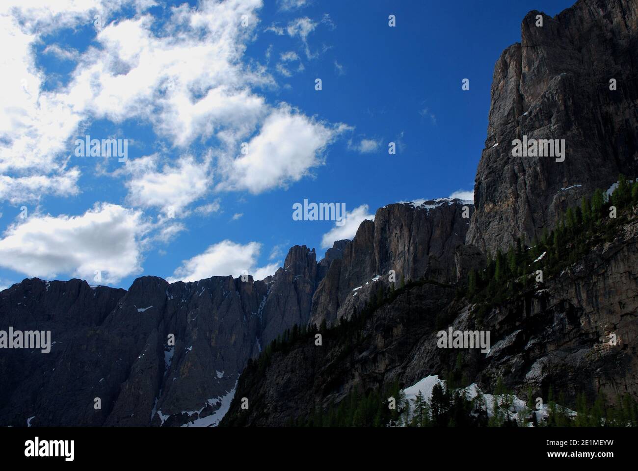 rocky mountain range with trees and blue sky Stock Photo