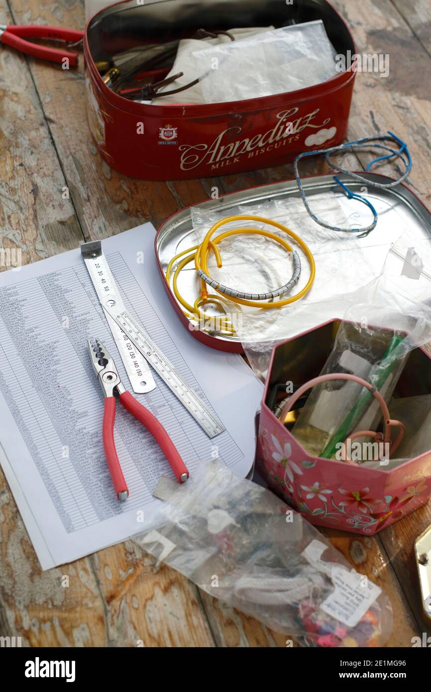 Table worktop for Bird Ringing, Pliers, ruler and bird rings, at Mai Po Nature Reserve, Hong Kong, China 26th Sept 2015 Stock Photo