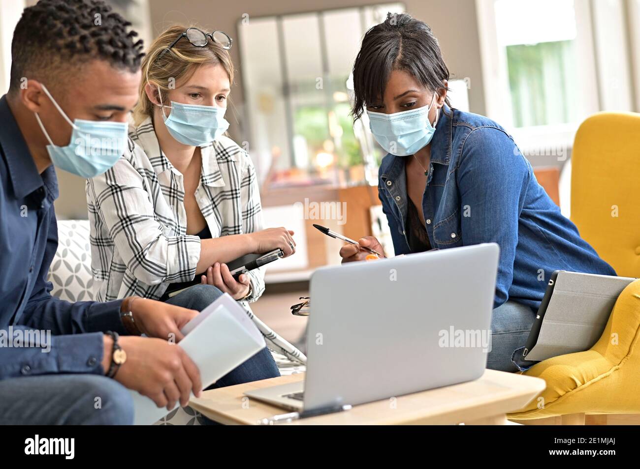 Business people meeting with face masks in the office Stock Photo